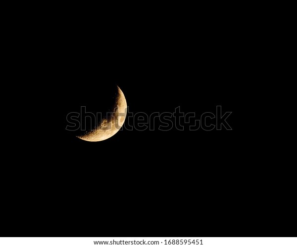 A\
Cresent Moon surrounded by the darkness of\
night.