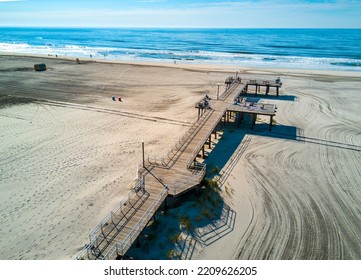 Crest Beach In Wildwood New Jersey On The Atlantic Ocean Beach With Wooden Dock From Above With The Ocean View And Tourists Relaxing