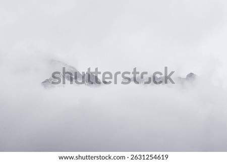 Crest of a mountain hidden behind the clouds