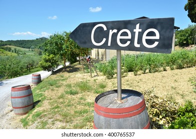 CRETE Arrow And Wine Barrels Along Rural Road