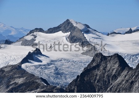Crevassed glaciers surround the beautiful knife edge summit of Eldorado Peak in North Cascades National Park - Washington, Pacific Northwest, USA