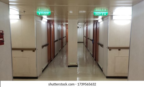 Crew Area Corridors And Hallways On A Cruise Ship With Emergency Exit Signs