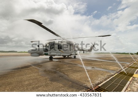 Crew cleaning Navy Sea Hawk helicopter after flight.