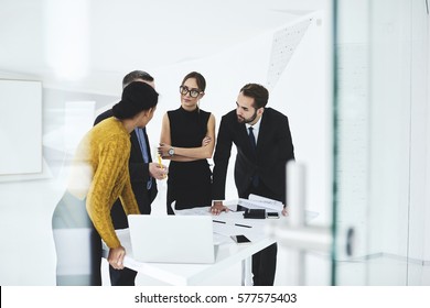 Crew of skilled marketing experts consulting with executive about rebranding of corporation suggesting new advertising campaign to change style sharing opinions on formal meeting in conference hall