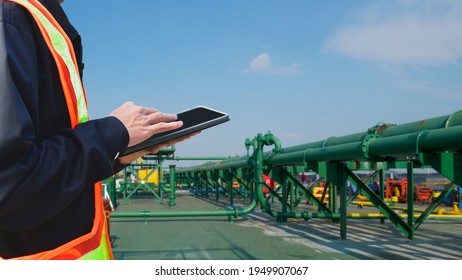 Crew Worker Hand Holding Search And Find Information IPad Air On Oil Tanker Ship During Ship Repair, Maintenance In Shipyard.