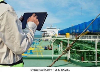 Crew Worker On Tanker Ship And Hand Holding IPad On Green Pipe Line Background