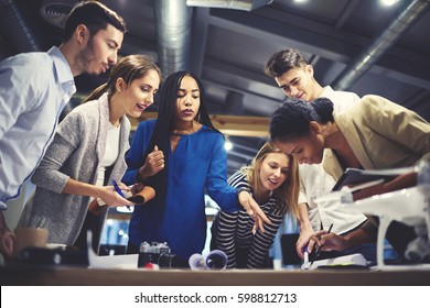 Crew of young male and female talented designers trainees discussing with skilled leader ideas for project consulting during informal meeting workshop planning strategy concept in coworking space - Shutterstock ID 598812713