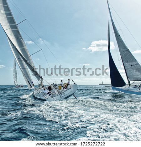 Crews sailing yachts at a sports regatta