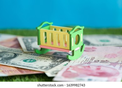 The Crib Is Empty, It Costs Money Conceptual Photo, Cost Of Maintaining A Child, Expenses For Raising Food, Clothing And Education.