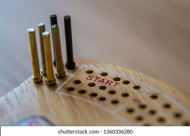 Cribbage board close up macro cards pegs holes game playing play start finish shallow depth field crib points diamond club spade heart