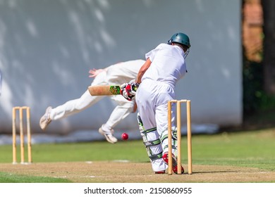 Cricket Action Batsman plays red ball delivered from bowler unrecognizable players abstract close-up photo between high schools game. - Powered by Shutterstock