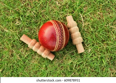 Cricket Ball And Bail On Green Grass