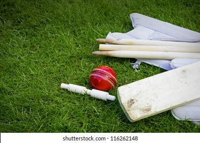 Cricket Ball, Bat & Pads With Stumps And Bail On Grass