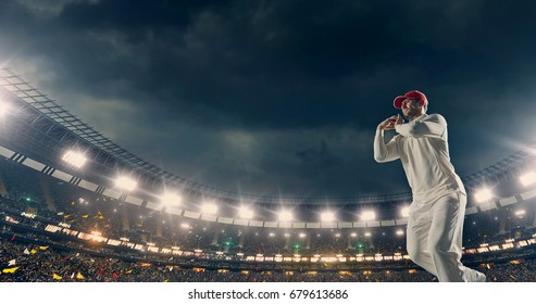 Cricket bowler in action on a professional stadium. The player wears unbranded clothes. The stadium is made in 3D. - Powered by Shutterstock