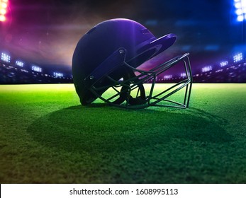 Cricket fans helmet from down view with 
green grass playground with lights focused on the object - Powered by Shutterstock