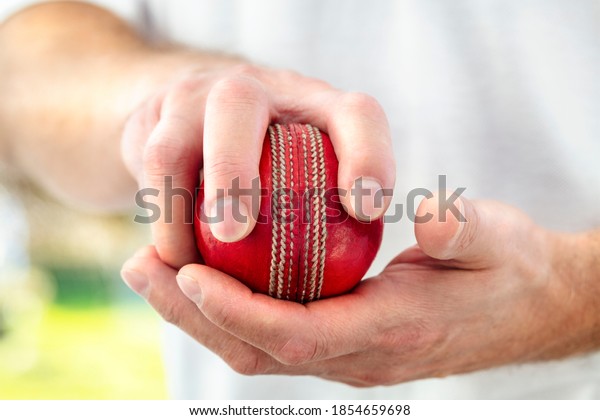 Cricket fast bowler holding ball close up\
approaching wicket