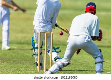 Cricket game action closeup unidentified  bowler ball batsman wicket keeper. - Powered by Shutterstock