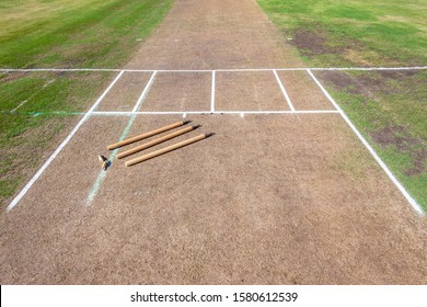 Cricket grass pitch prepared for game closeup wickets bails painted crease batting white lines. - Powered by Shutterstock