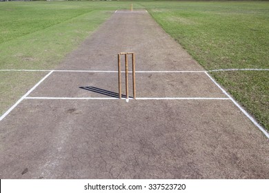 Cricket Pitch Wickets
Cricket field game pitch wickets bails white crease grass arena.