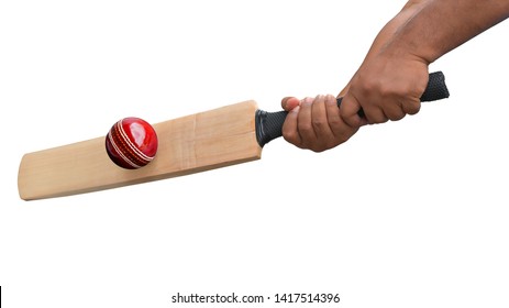 Cricket player holding crickets bat on hand  hitting red cricket ball isolated on white background. This has clipping path.  
