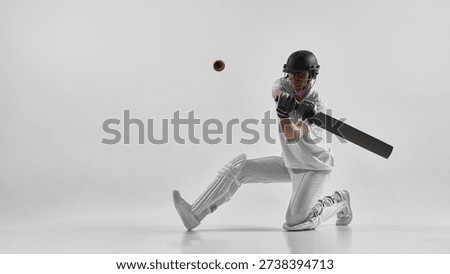 Cricket player kneeling while hitting ball isolated on white background. Concept of cricket training materials, youth sports enrollment campaigns, coaching website visuals and sports education content