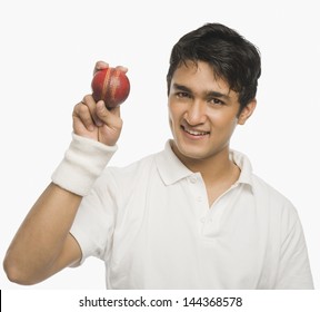 Cricket player showing a cricket ball - Powered by Shutterstock