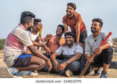 Cricket players discussing with talking each other after playing sports while sitting on playground - concept of friendship, taking break and communication - Powered by Shutterstock