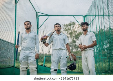 Cricket players standing a giving team poses in cricket nets in practice time - Powered by Shutterstock