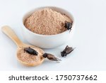 Cricket powder insect and pile Gryllus Bimaculatus for eating as food items made of insect meat in bowl on white background is good source of protein edible for future and entomophagy concept.