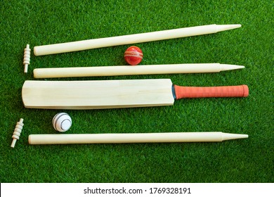 cricket set bat ball stumps and bails on green grass pitch background - Powered by Shutterstock