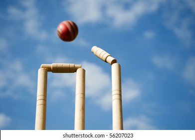 Cricket stumps and bails hit by a ball - Powered by Shutterstock