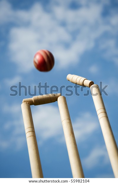 Cricket stumps and bails\
hit by a ball