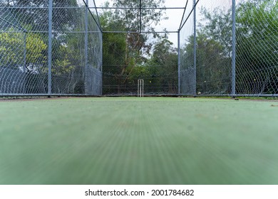 Cricket stumps in nets. Wickets on cricket pitch surrounded by metal net in Australia