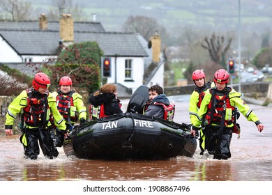 Crickhowell, Powys, Storm Dennis, February 2020. The Small Town Was Devastated By Flooding.  Fire Crews Rescue A Couple By Boat From A BB On Bridge Street. 