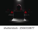 Crime and attack technology concept by hacker , Grey laptop with black blank screen and red hacker blurred in a black darkness background with lights shining down from above.