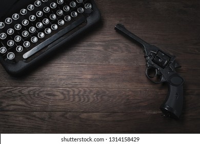 Crime Fiction - Old Retro Vintage Typewriter And Revolver Handgun On Wooden Table