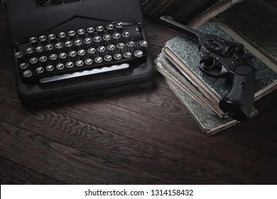 Crime Fiction - Old Retro Vintage Typewriter And Revolver Handgun On Wooden Table