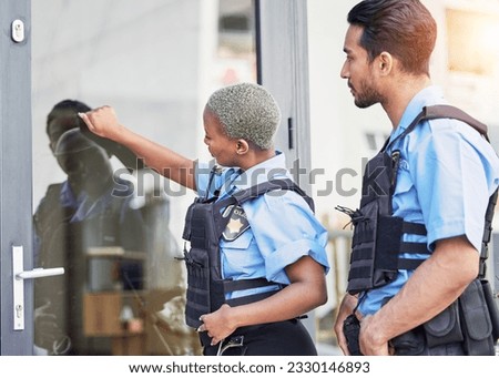 Crime, patrol and police knocking on a door for justice, security and law at a home. Together, teamwork and a black woman and man at a house for service, check and helping the community for work