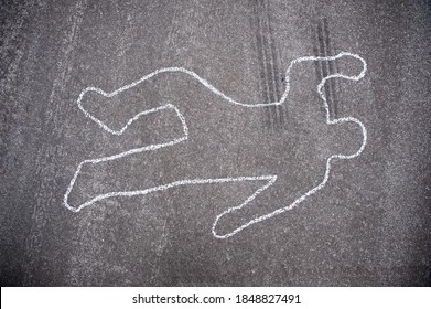 Crime scene chalk line of an auto accident with tire skid marks leading over the body. - Shutterstock ID 1848827491