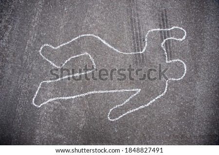 Crime scene chalk line of an auto accident with tire skid marks leading over the body.