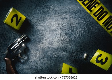 Crime Scene Concept With A Gun And Evidence Markers / High Contrast Image