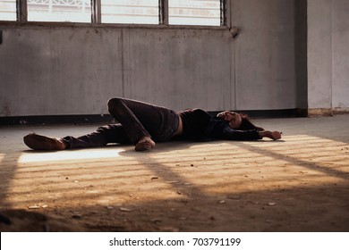 Crime Scene Concept Photo Of A Murder Victim Woman Lying Dead On The Ground Of Old Building.