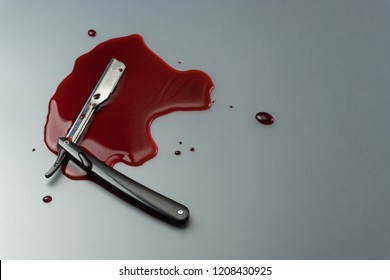 Crime Scene Concept, A Vintage Straight Razor In Pool Of Blood