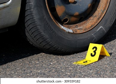 Crime Scene Evidence Marker Near To Tire