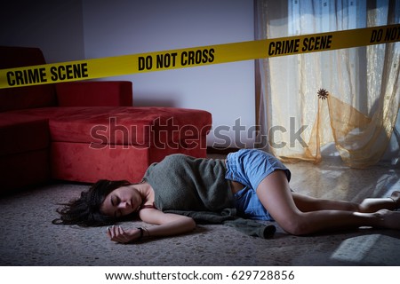 Crime scene imitation. Lifeless woman lying on the floor