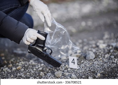 Crime scene investigation - collecting pistol on forest way