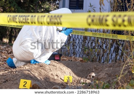 Crime scene investigation. Forensic science specialist working on human remains identification.