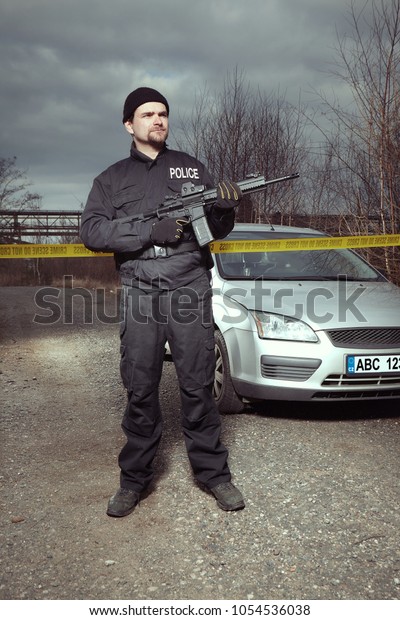 Crime scene investigation - police officer\
guarding place of\
investigation