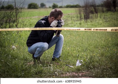 The Crime Scene, Murder, Investigation, Bloody Knife On The Grass, An Investigation Is Underway, Expert Witness With A Camera Image Evidence For Murder