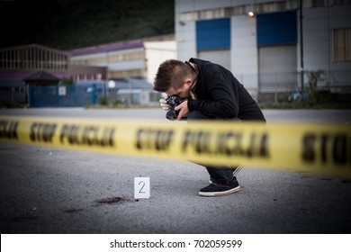 Crime scene, murder, investigation, bloody trail on asphalt, ongoing investigation, camera expert evidence of murder